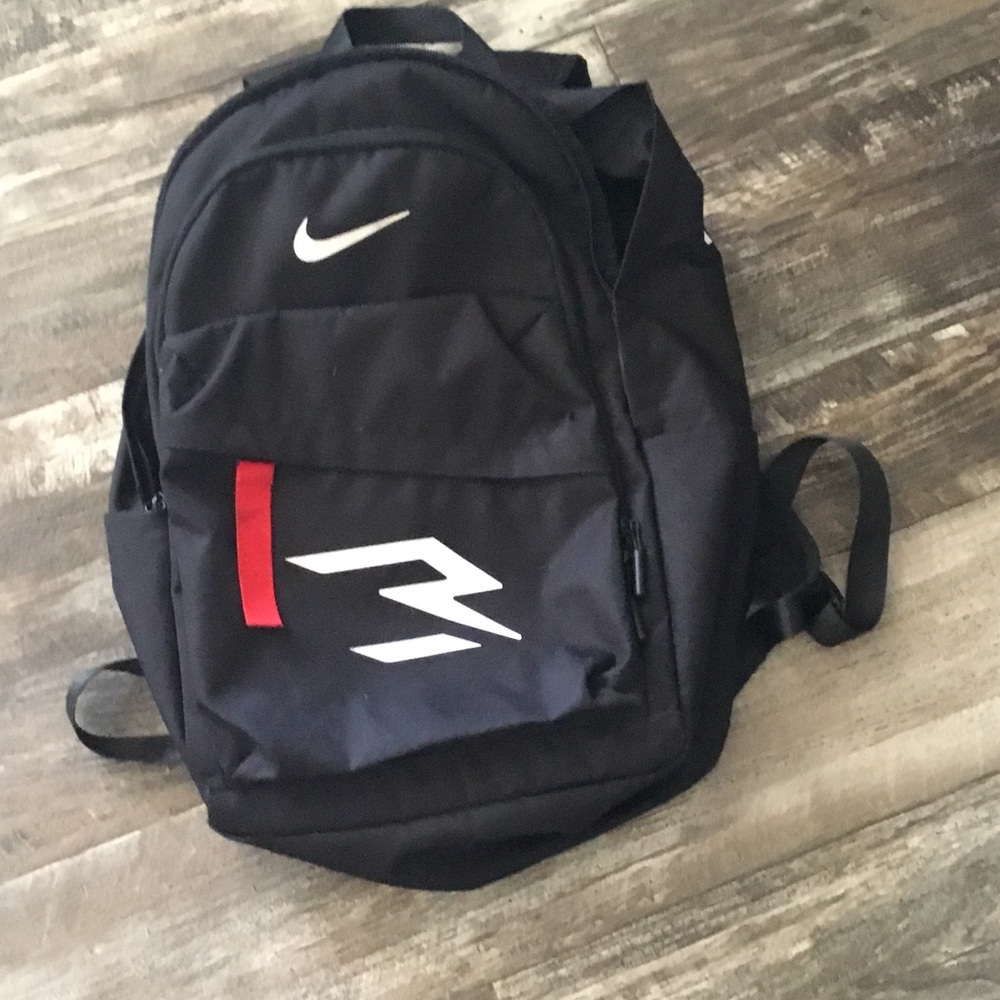 Nike Black Backpack with White Swoosh and Red Tab
